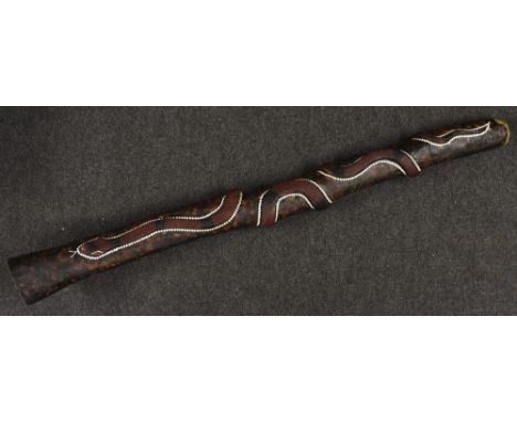 An Australian didgeridoo, typically constructed of termite-bored hardwood, carved in relief with a snake and painted with dot