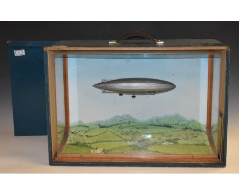 Aeronautica - a museum landscape diorama, the R. 100 Airship, British c. 1925, labelled, flies over a rural scene, 34cm high,
