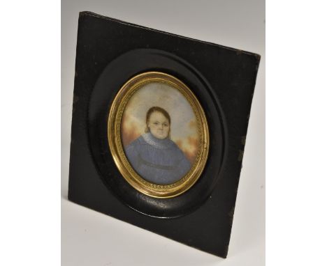 Continental School (19th century), a portrait miniature, of a young girl wearing a blue dress, watercolour on ivory, oval, 6.