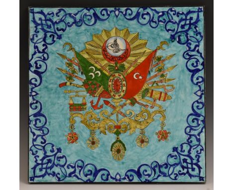 A large Turkish tile, brightly decorated with the coat of arms of the Ottoman Empire, on a turquoise ground, 40cm square  Con