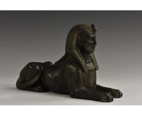 A 19th century French bronzed gun metal mantel model, of an Egyptian sphinx, traces of verdigris patination, 14cm high, 22cm 