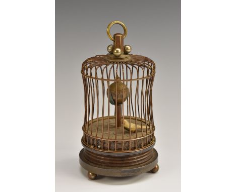 A brass novelty automaton table clock, as a bird in a cage, central posted globular dial with Arabic numerals, the bird oscil