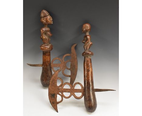 Tribal Art - an African axe, shaped and pierced blade, the club shaped handle carved as a figure, 44cm long; another, similar