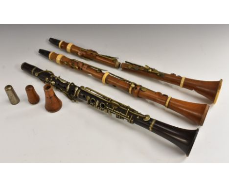 A 19th century boxwood clarinet, Bilton, London, 59.5cm long, c.1850; another, similar, stamped Gisborne; another, rosewood, 