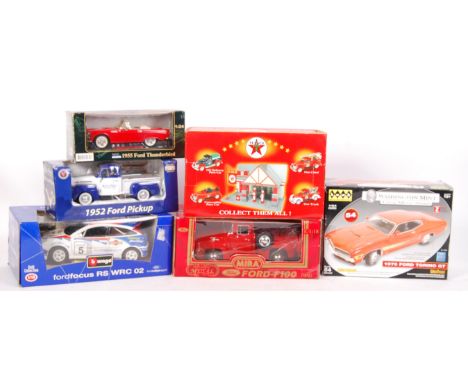 A good collection of 6x larger scale boxed diecast model cars and related. To include; 1:18 scale Burago Ford Focus, MIRA 1:1