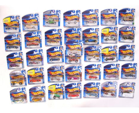 A collection of 36x assorted Hot Wheels carded diecast model cars by Mattel. Largely from the 2002 series. All appear mint an