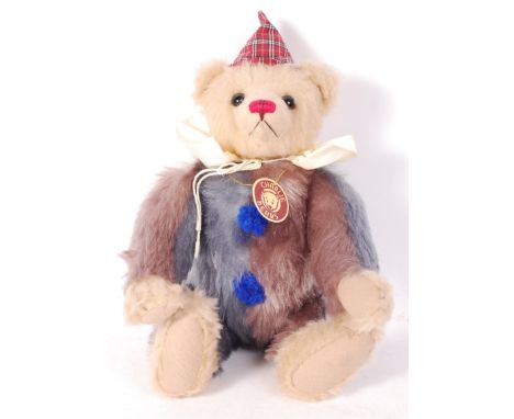 A Charlie Bears made teddy bear CB094070 ' Felix '. Clown themed, with multi-coloured mohair, glass eyes and hat. Appears min