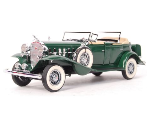 A Danbury Mint made precision diecast model 1:24 scale ' 1932 Cadillac '. Green, with cream interior. Appears mint, within it