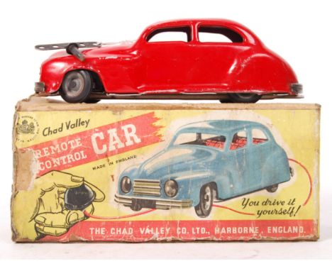 An original vintage Chad Valley made Remote Control Car tin plate mechanical clockwork toy car in red, within the original bo