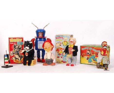 A good collection of 6x assorted vintage tinplate clockwork toys. Three boxed examples, to include; ' Musical Clown ', ' Hung