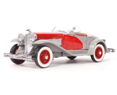 A Danbury Mint made precision diecast model 1:24 scale ' 1935 Duessenberg Speedster '. Red and grey, with brown interior. App