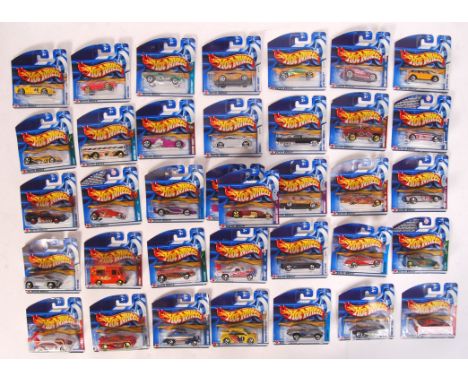 A collection of 36x assorted Hot Wheels carded diecast model cars by Mattel. Largely from the 2002 series. All appear mint an