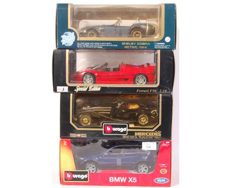 A collection of 4x 1:18 scale precision diecast model boxed cars. Comprising; a Burago / Bburago ' BMW X5 ', Burago 3023 Merc