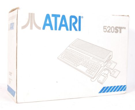 An original vintage Atari 520ST computer video games console with original power cable, TV aerial cable, and mouse within the