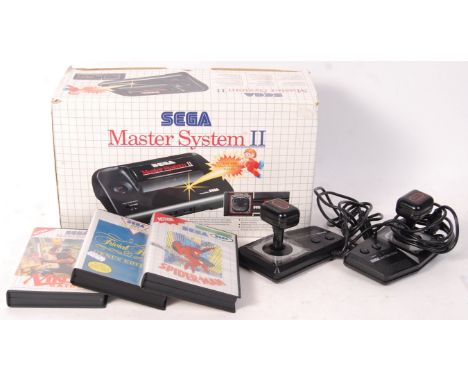 A Sega Master System II computer games console in the original box complete with 2 x Sega joysicks, Sega control pad, aerial 