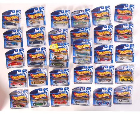 A collection of 32x assorted Hot Wheels carded diecast model cars by Mattel. Largely from the 2002 series. All appear mint an