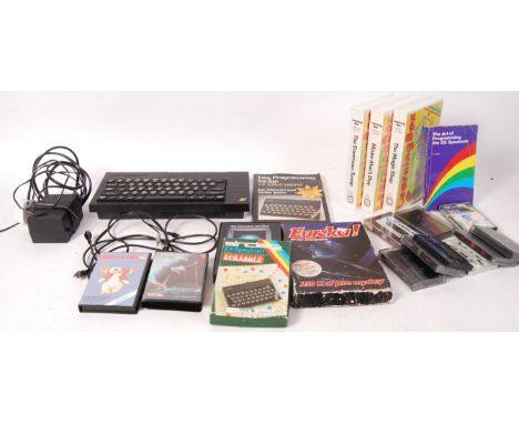 A Sinclair ZX Spectrum computer games console complete with aerial cable and A/C adaptor together with a selection of games t