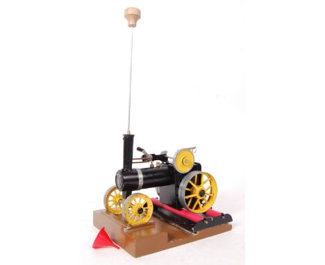 An original Mamod made live steam traction engine in a black and yellow colourway together with a Mamod rolling road being fi