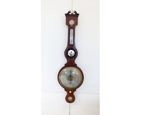 A mahogany boxwood and ebony strung wheel barometer, early 19th century, the broken scroll swan neck pediment flanking an ivo