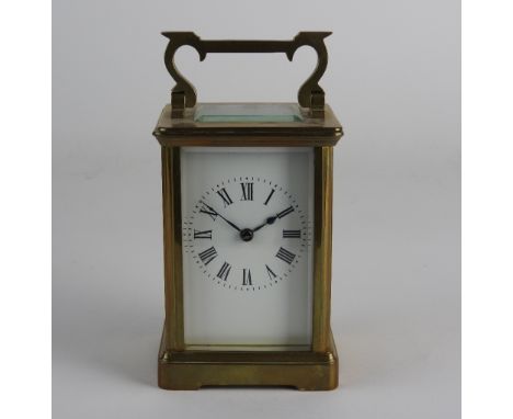 An early 20th century French gilt brass carriage clock the 2 inch white enamel dial with ring of Roman numerals, the movement