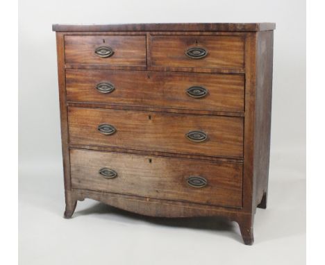 A George III mahogany chest of drawers, late 18th/early 19th century, the rectangular top above two short and three long cock