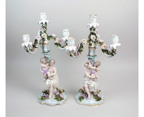 A pair of Sitzendorf porcelain figural candelabra, 19th century, each column as a mother and infant on a rose strewn plinth i