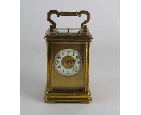 An early 20th century French gilt brass carriage clock the 2 inch diameter chapter ring of Arabic numerals in a presentation 