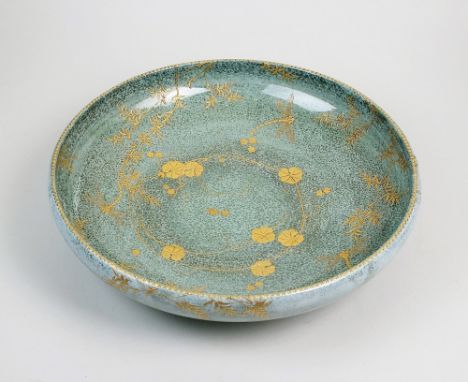 A rare Royal Doulton 'Titanium' ware bowl, of shallow circular form, decorated with raised paste gilt dragonflies amid flower