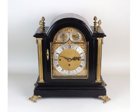 An Edwardian ebony cased bracket clock, in Georgian revival style, the arched case enclosing an arched dial with silvered cha