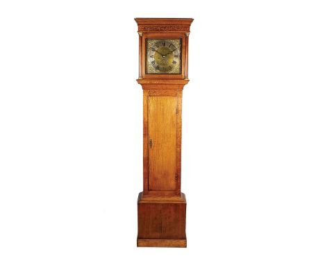 A George III oak longcase clock, the ogive moulding above a blind fret carved cornice and glazed square door flanked by turne