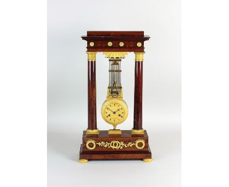 A French Empire mahogany and ormolu portico clock, 19th century, the 4.5'' dial with engine turned centre and Roman numerals 