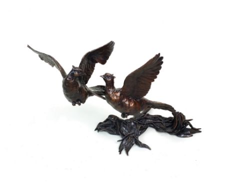 A modern bronze group of a cock and hen pheasant breaking cover, 20th century, unsigned on a base cast with leaves, 18cm high