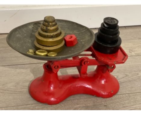 vintage balance scales in red with loose weights