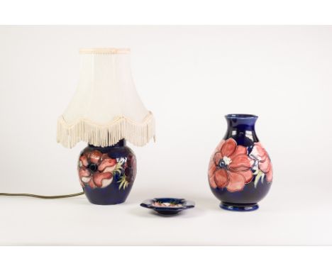 THREE PIECES OF WALTER MOORCROFT ANEMONE PATTERN TUBE LINED POTTERY ON BLUE GROUNDS, comprising: GINGER JAR PATTERN TABLE LAM