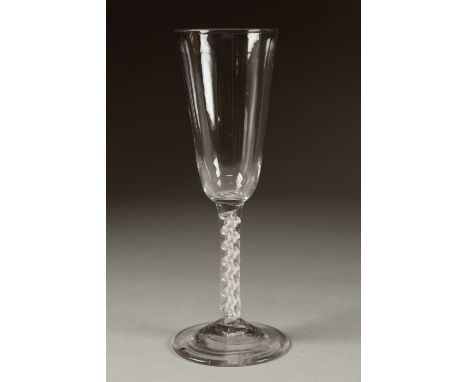 AN EIGHTEENTH CENTURY MERCURIAL TWIST ALE GLASS, the tall, rounded funnel bowl above a stem with central corkscrew, on a coni