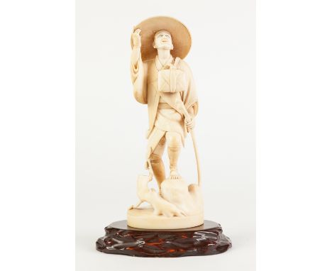 A FINE JAPANESE MEIJI PERIOD ONE PIECE CARVED IVORY OKIMONO of a man ascending a landscape holding a walking stick, his left 