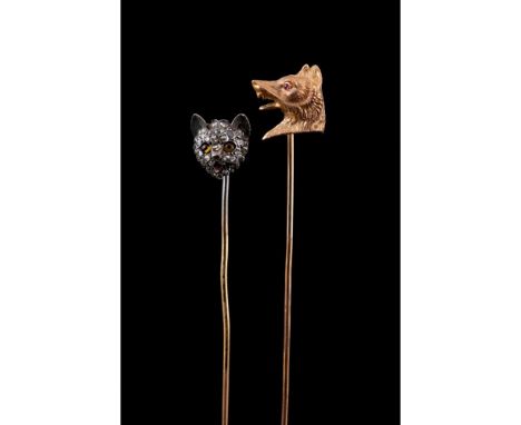 Two tie pinsCat's Head pinGold and silver with applied enamel elementSet with rose cut diamondsWolf Head pinChiselled gold se