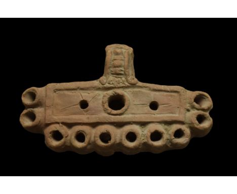 Ca. 100-300 AD.A rare example of a terracotta oil lamp featuring an elongated body with a decorated unpierced handle and cent