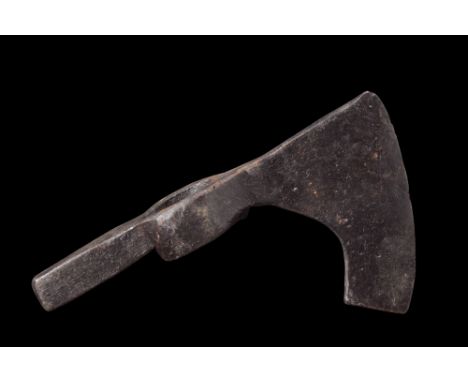Ca. 900-1100 AD.An iron axe head featuring a curved cutting edge that extends below the width of the butt. The curvature of t