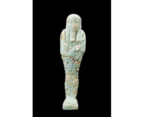 Late Period, Ca. 664-332 BC.A mummiform figure crafted from light-blue faience and adorned with a delicate glazed finish, thi