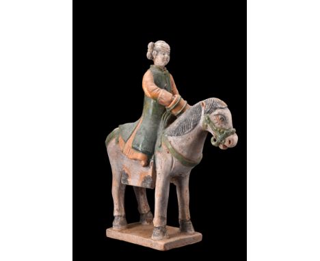 Ca. 1368-1644 AD, or later.A pottery mingqi, depicting a captivating horse and a female rider gracefully positioned atop. The