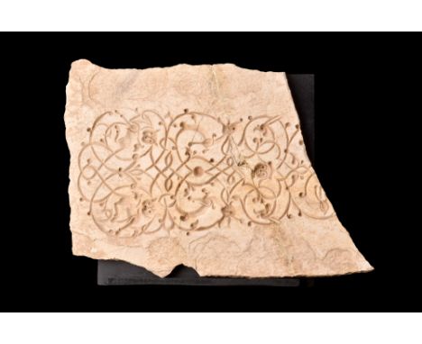 Ca. 1100-1200 AD.A stone fragment of a frieze with its slender profile and rich decorative embellishments on the upper face. 