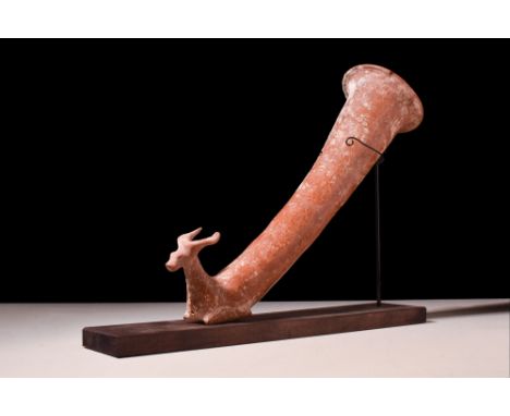 Ca. 330-200 BC. The slender terracotta rhyton formed with a flaring lip and conical shaped body terminating into a stag proto