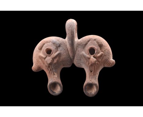 Ca. 100-300 AD.A terracotta double "frog lamp" comprises unique design of two individual lamps that are intricately joined to