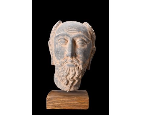 Ca. 200-300 AD or later.A schist head of a nobleman, a stunning masterpiece of art that reflects the remarkable fusion of Gre