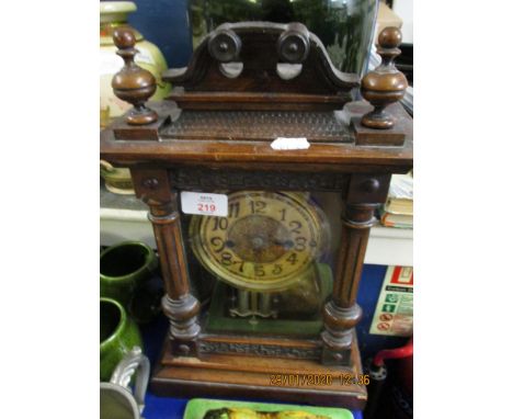 WALNUT CASED MANTEL CLOCK WITH CARVED DETAIL