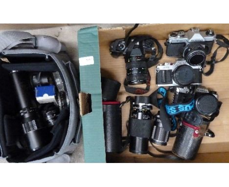 Two Pentax cameras, K1000 and P30, an Olympus OM10 camera, a Canon AV-1 camera and a collection of lenses