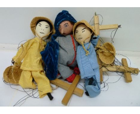 A wooden puppet and two oriental puppets