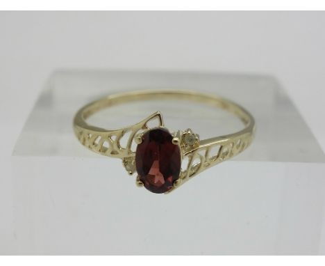 A 9ct gold, diamond and garnet ring, weight 0.9g, size N