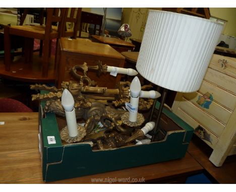 A quantity of wall lights and a table lamp.